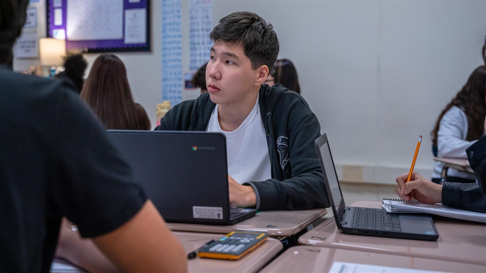 High school student using a laptop.